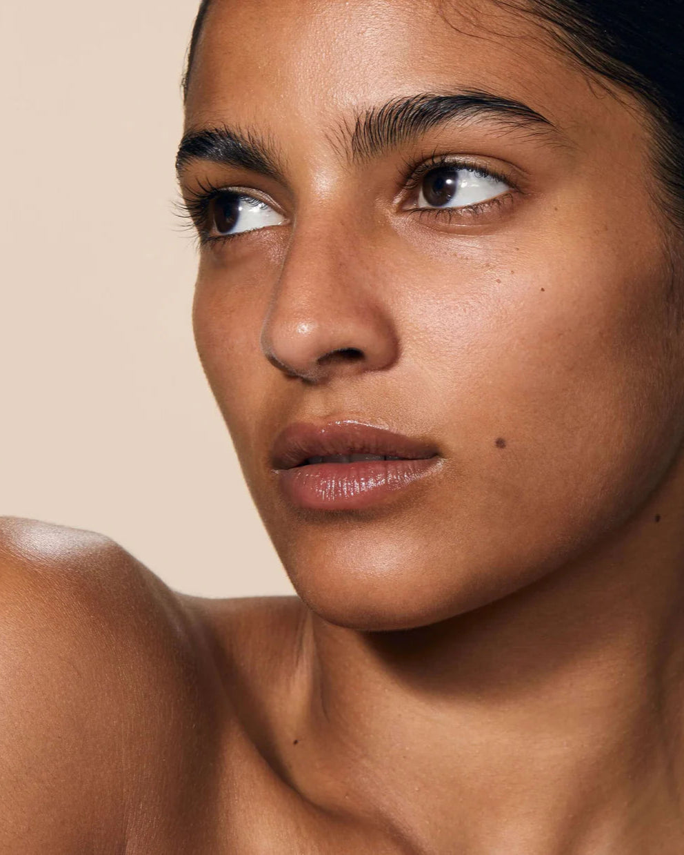 Close-up of a woman's face with a neutral background