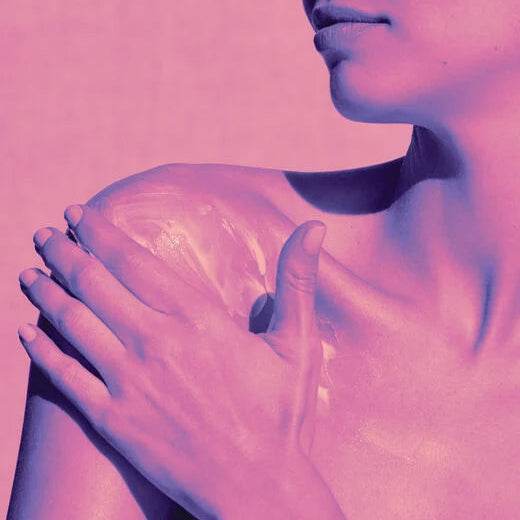 Applying Natura Bisse Diamond Extreme Body Cream | Age Defying Body Cream on shoulder for smooth skin