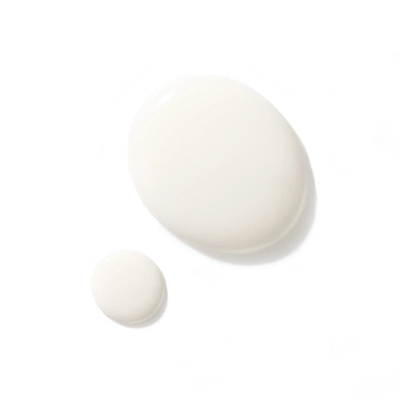 Two drops of Augustinus Bader Light Cream on a white background for skincare enthusiasts