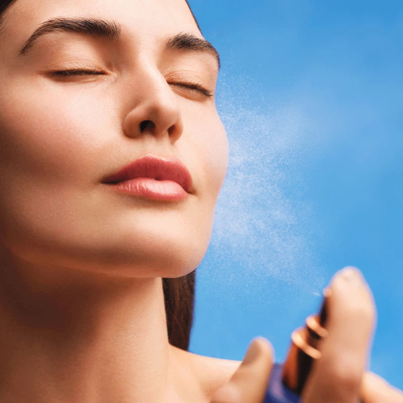 Women applying Augustinus Bader The Face Mist for refreshed and hydrated skin