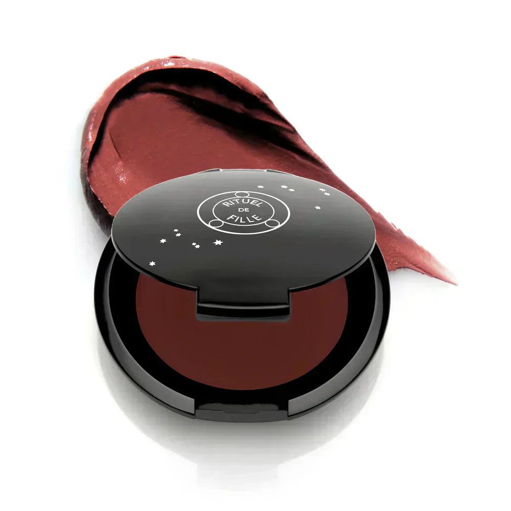 Rituel de Fille Cream Blush in a sleek black compact with a swatch of deep berry color