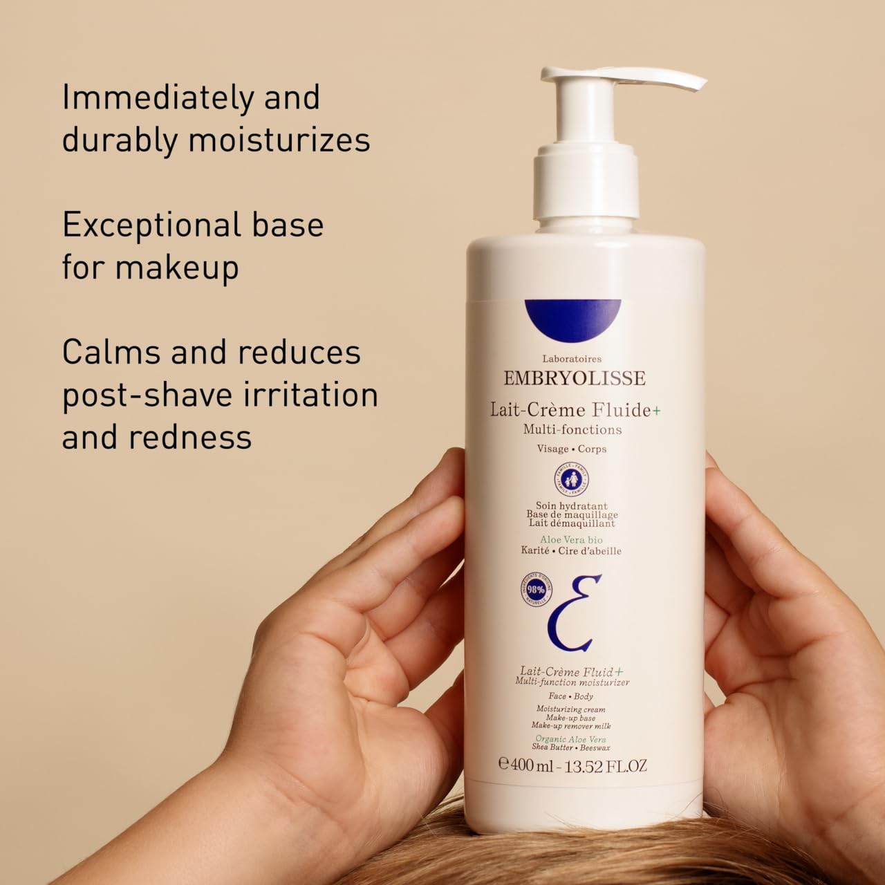 Embryolisse Lait-Creme Fluide moisturizer bottle held by hands with moisturizing and makeup base benefits