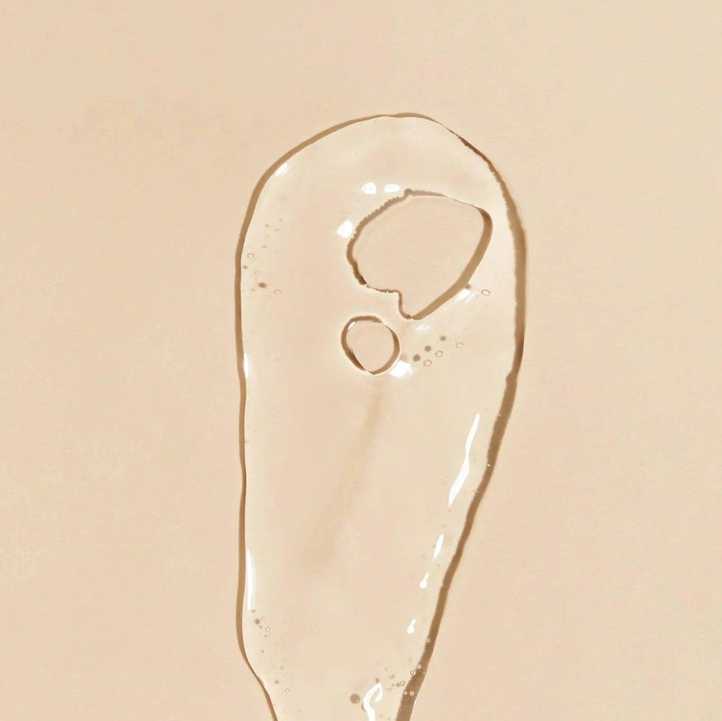 Clear gel texture of Goldfaden MD Fresh A Peel | Multi Acid Resurfacing Peel on beige surface