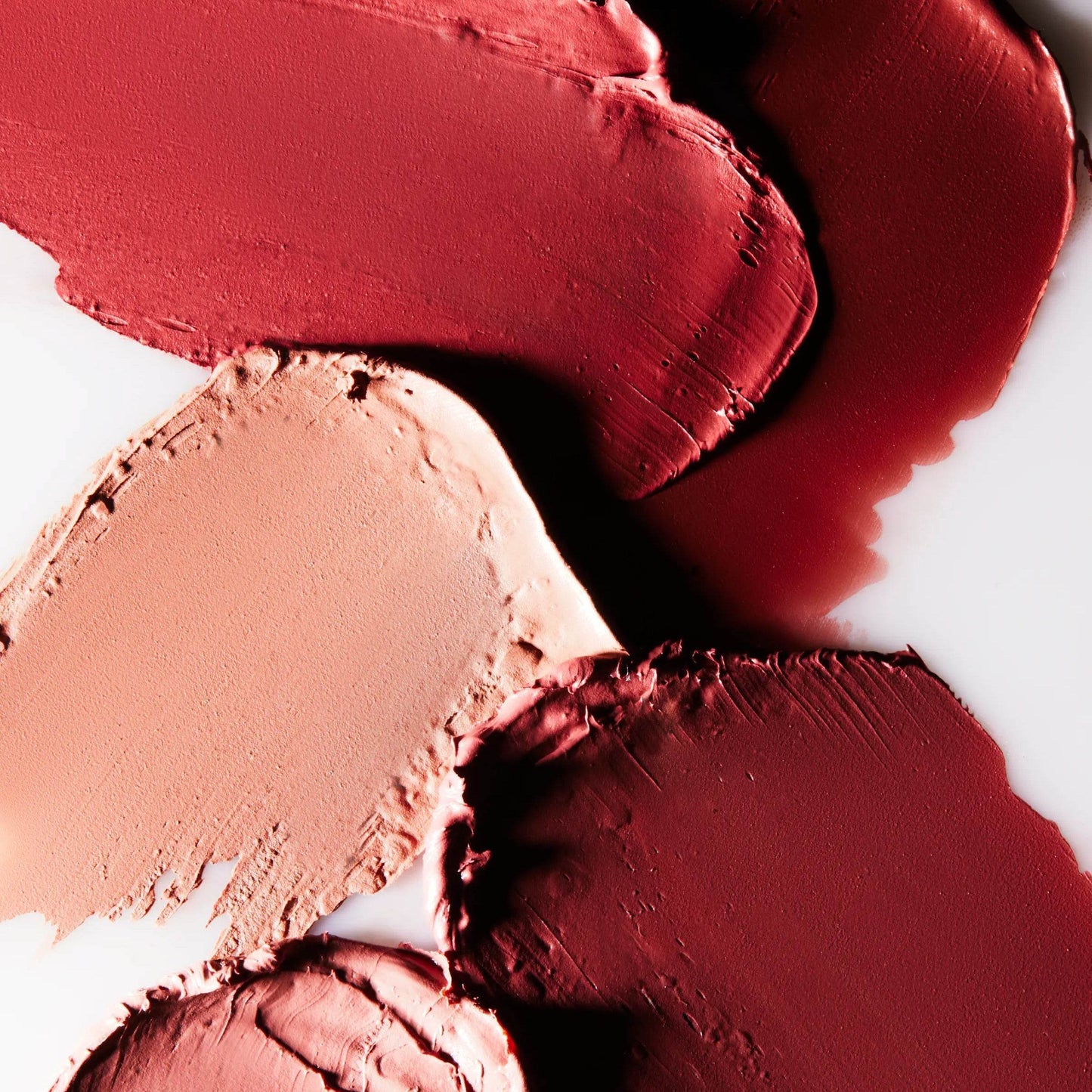 Various shades of Wonderblush Lipstick swatches on a white background