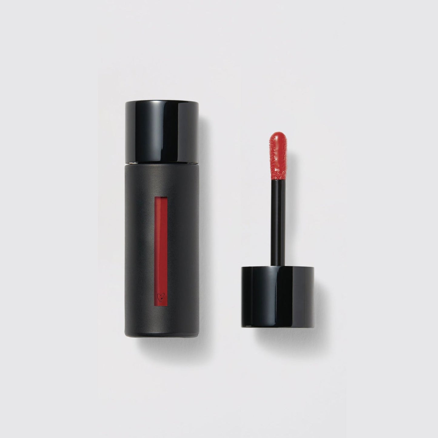 Westman Atelier Liquid Tinted Lip Balm in a sleek black tube with a precision applicator for effortless application