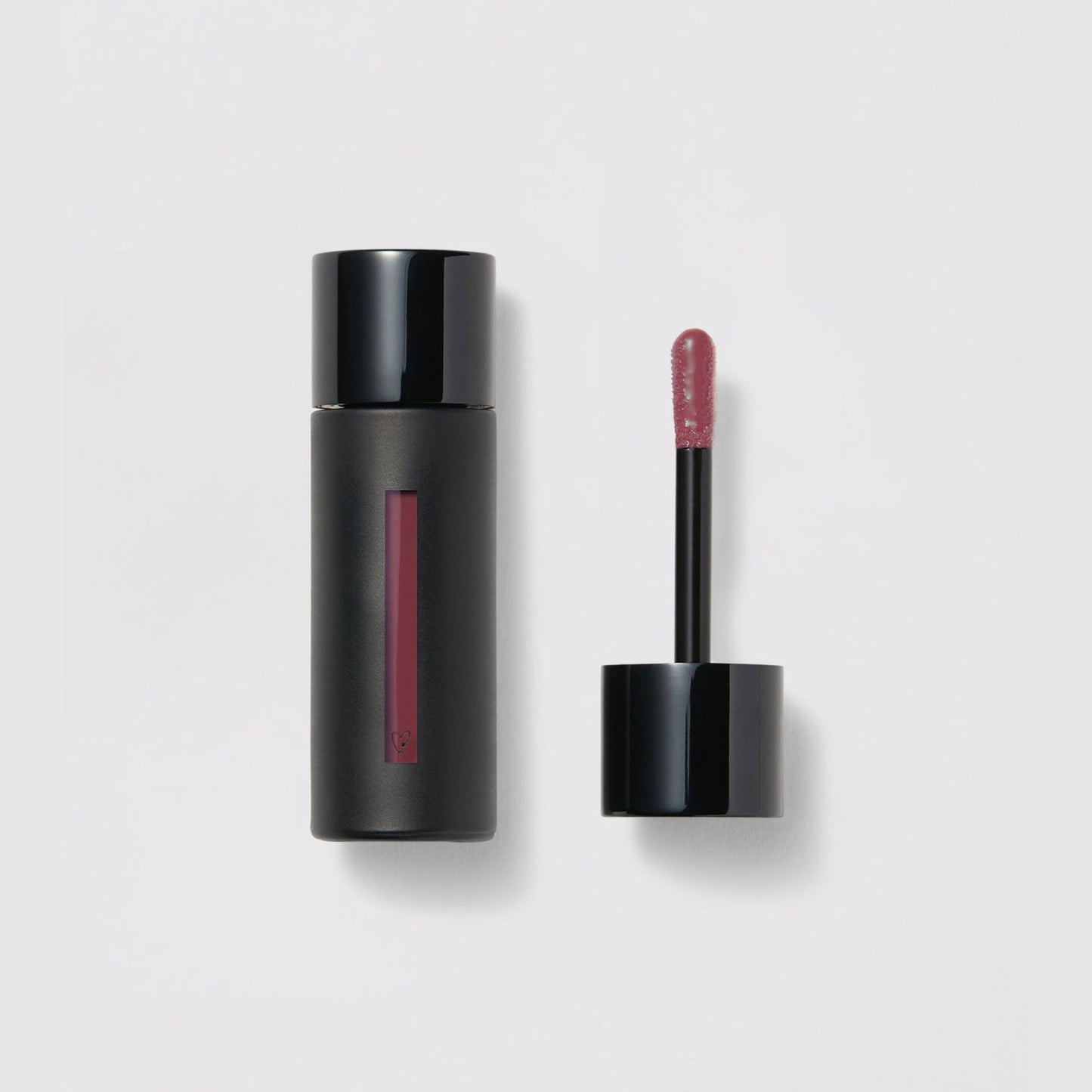 Westman Atelier Liquid Tinted Lip Balm in dark shade with applicator for versatile lip color