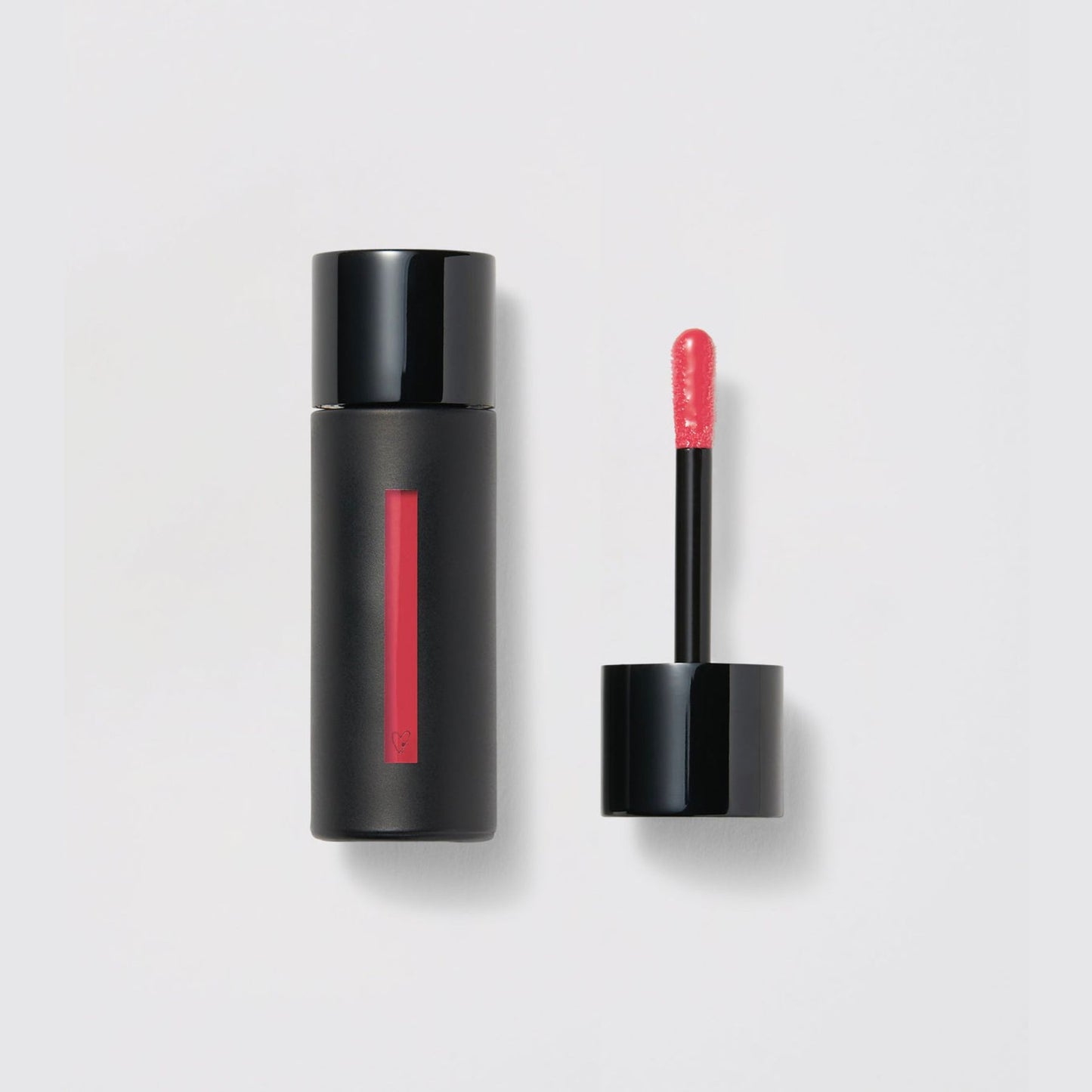Westman Atelier Liquid Tinted Lip Balm in a sleek black tube with applicator for vibrant lips