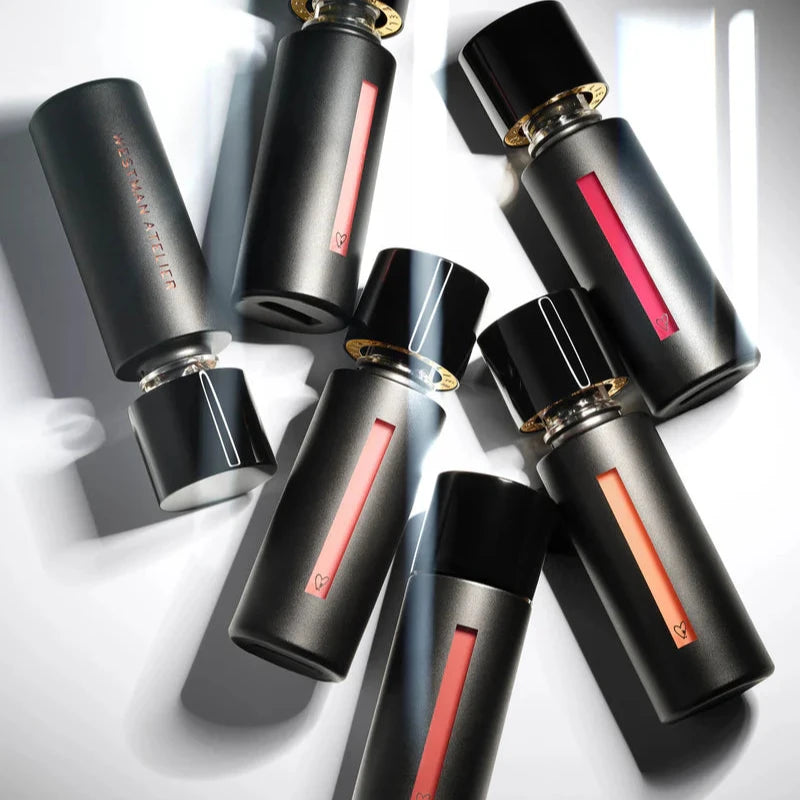 Westman Atelier Liquid Tinted Lip Balm in stylish black packaging with colorful shades displayed elegantly