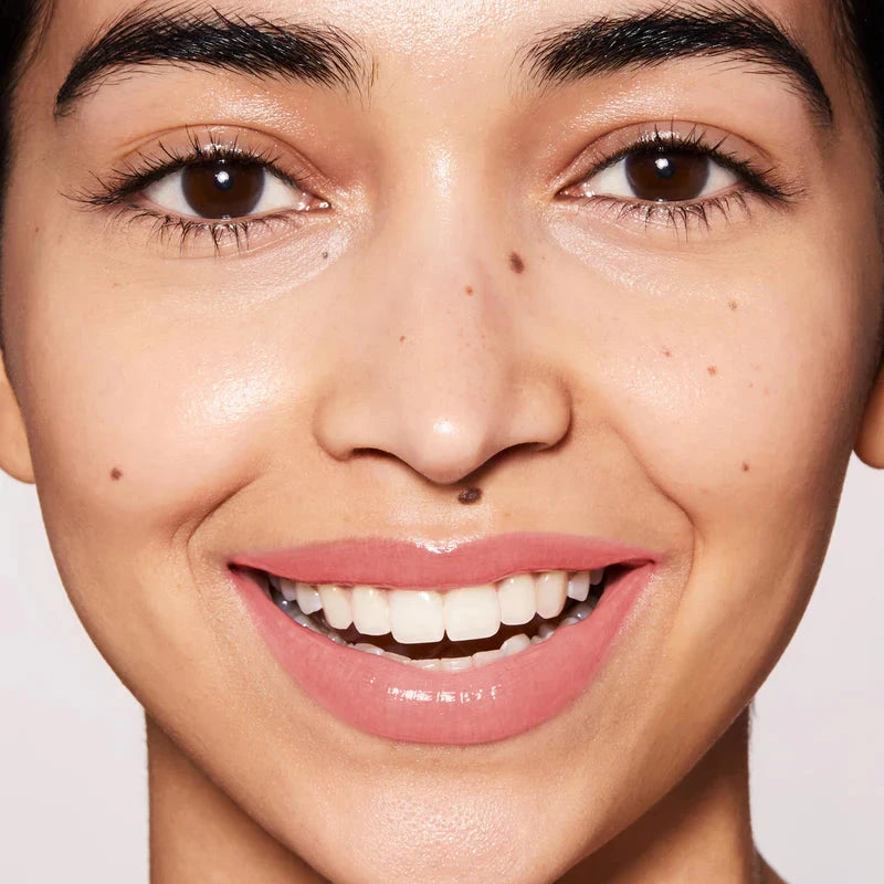 Model showcasing a natural look with Liquid Tinted Lip Balm for a subtle glow and hydration