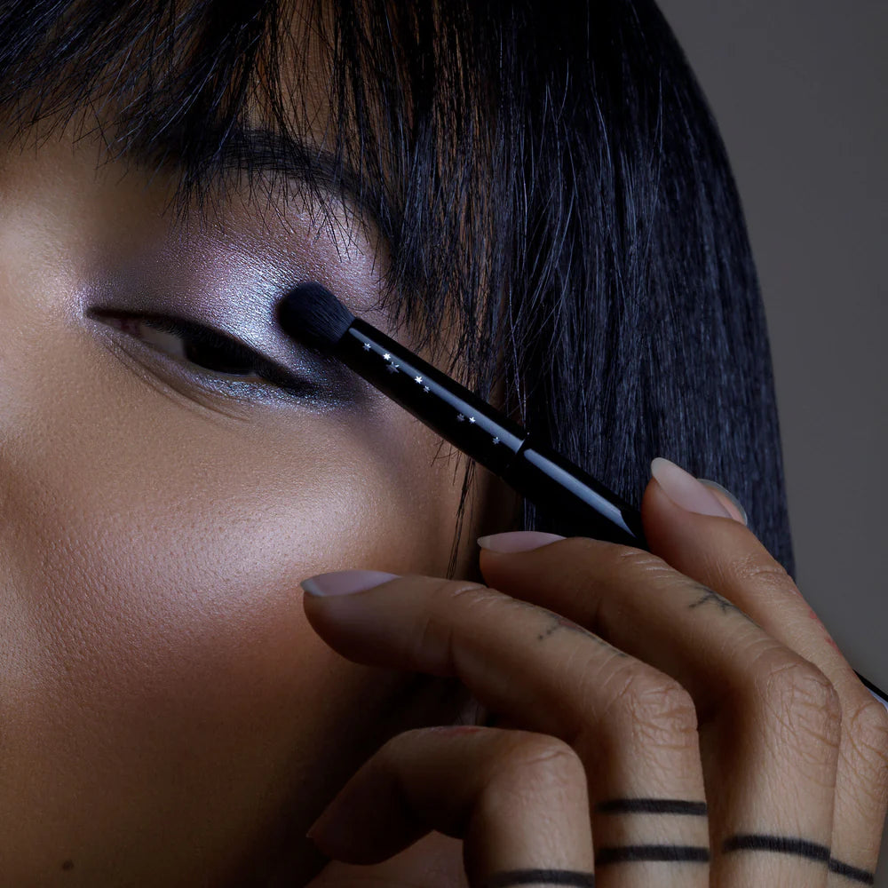 Rituel de Fille Eyeshadow Brush applying shimmering shadow for a flawless look