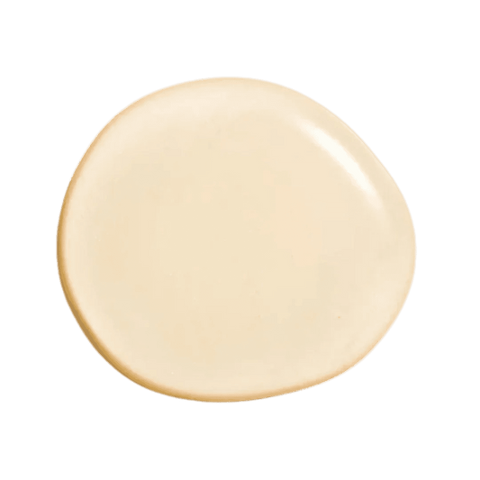 Natura Bisse Cleansing Exfoliating Gel in a smooth cream texture on a dark background