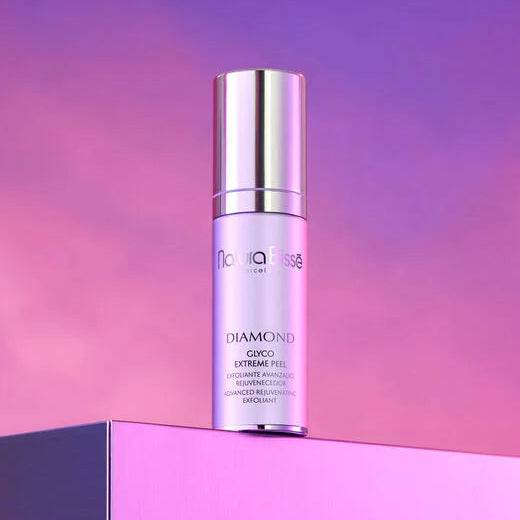 Natura Bisse Diamond Glyco Extreme Peel Advanced Rejuvenating Exfoliant bottle on pink and purple gradient background
