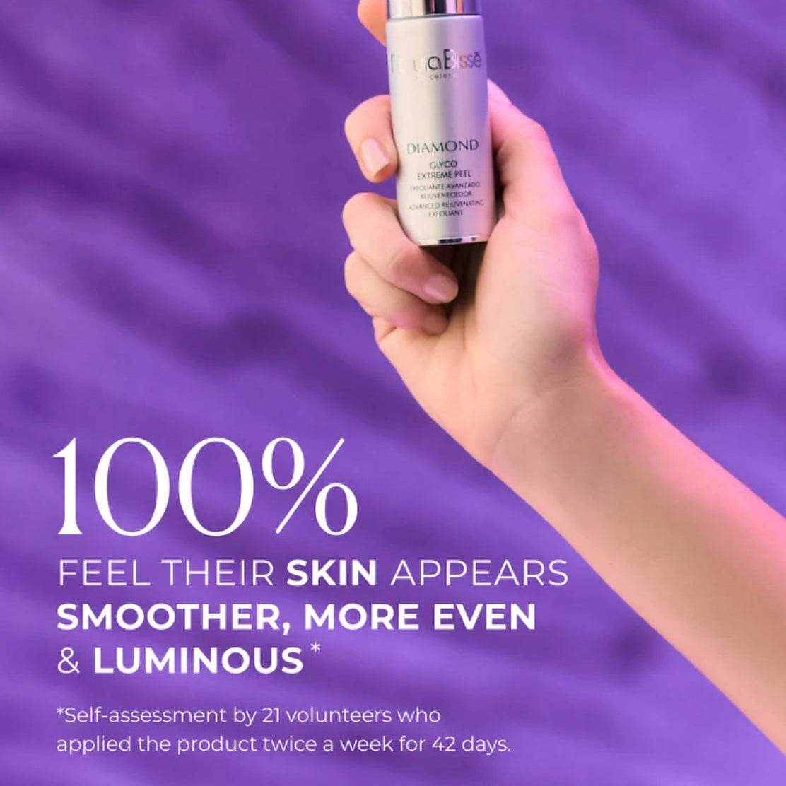 Hand holding Natura Bisse Diamond Glyco Extreme Peel Advanced Rejuvenating Exfoliant bottle on purple background