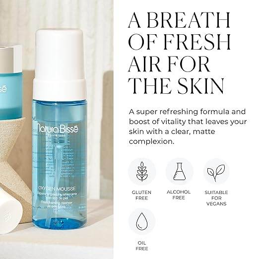 Natura Bissé Fresh Foaming Cleanser in blue bottle with white cap and skin benefits icons