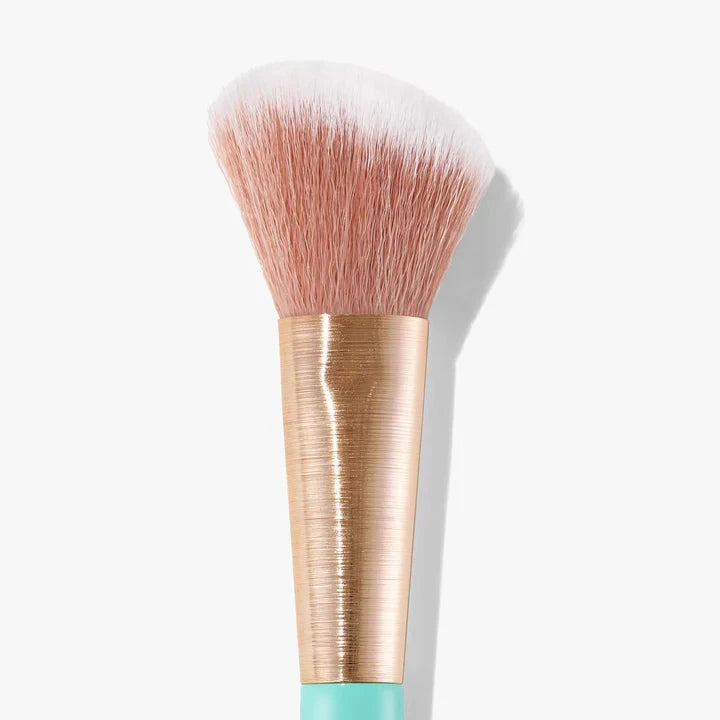 Sweed angled blush brush with soft bristles and a sleek gold and turquoise handle
