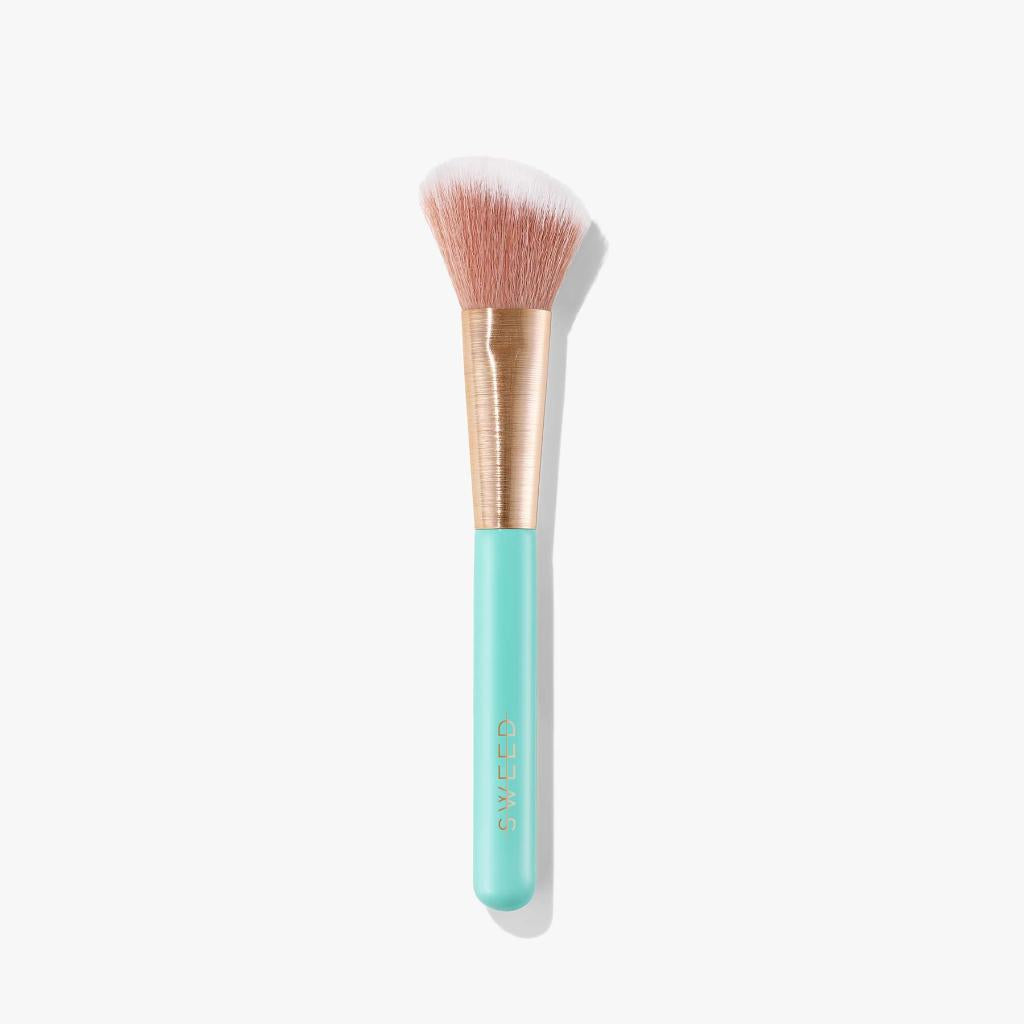 Sweed angled blush brush with a soft bristle head and a stylish mint green handle