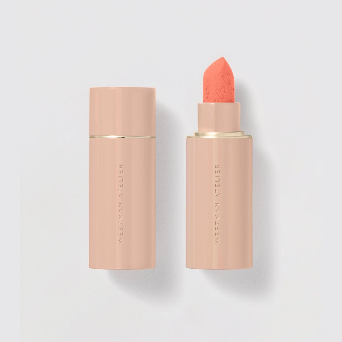 Westman Atelier Comfortable Matte Lipstick in a peach shade with a sleek packaging design