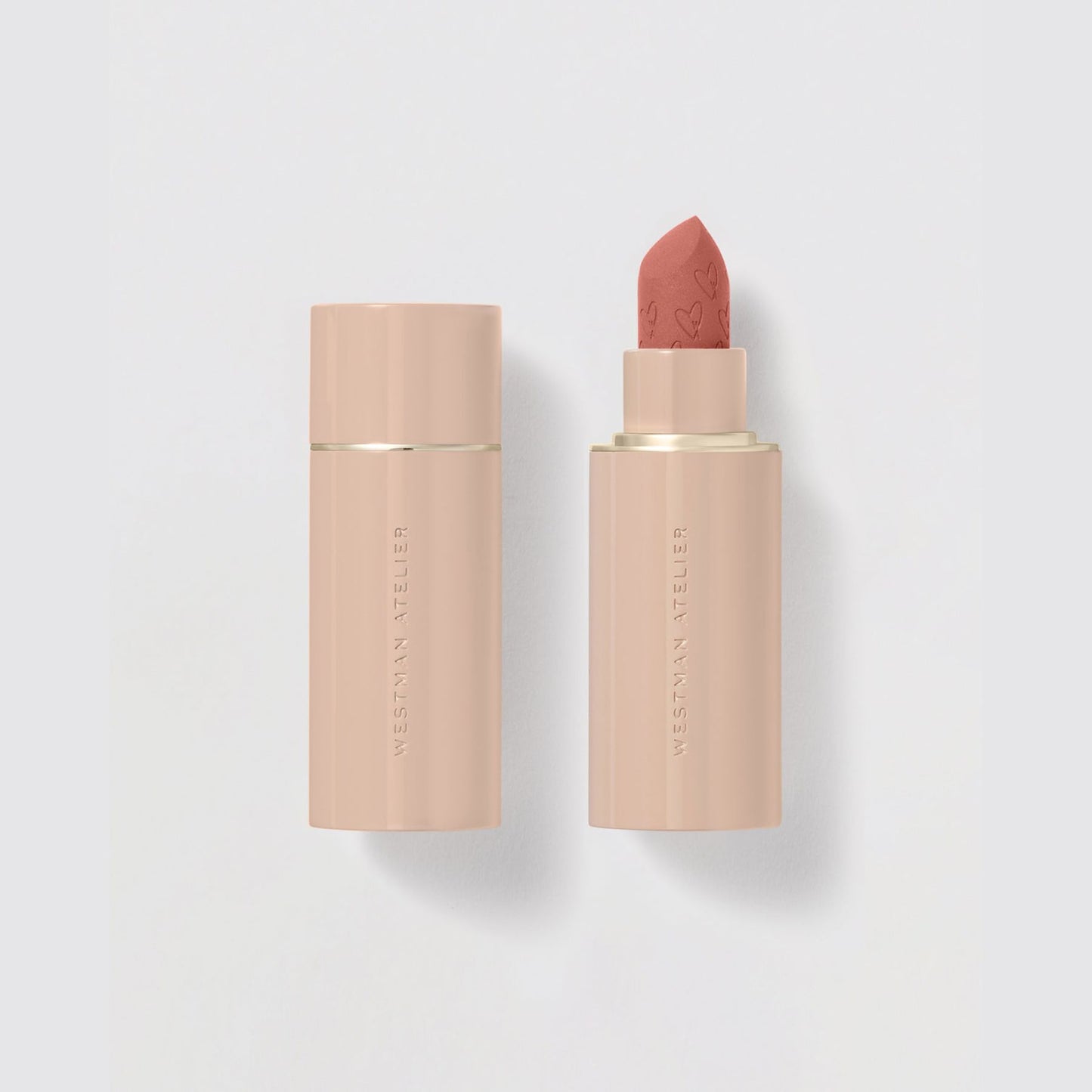 Westman Atelier Comfortable Matte Lipstick in soft nude shade with embossed heart design on lipstick