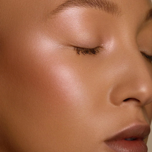 Close-up of radiant skin showcasing glowy summer essentials for a fresh and glowing look