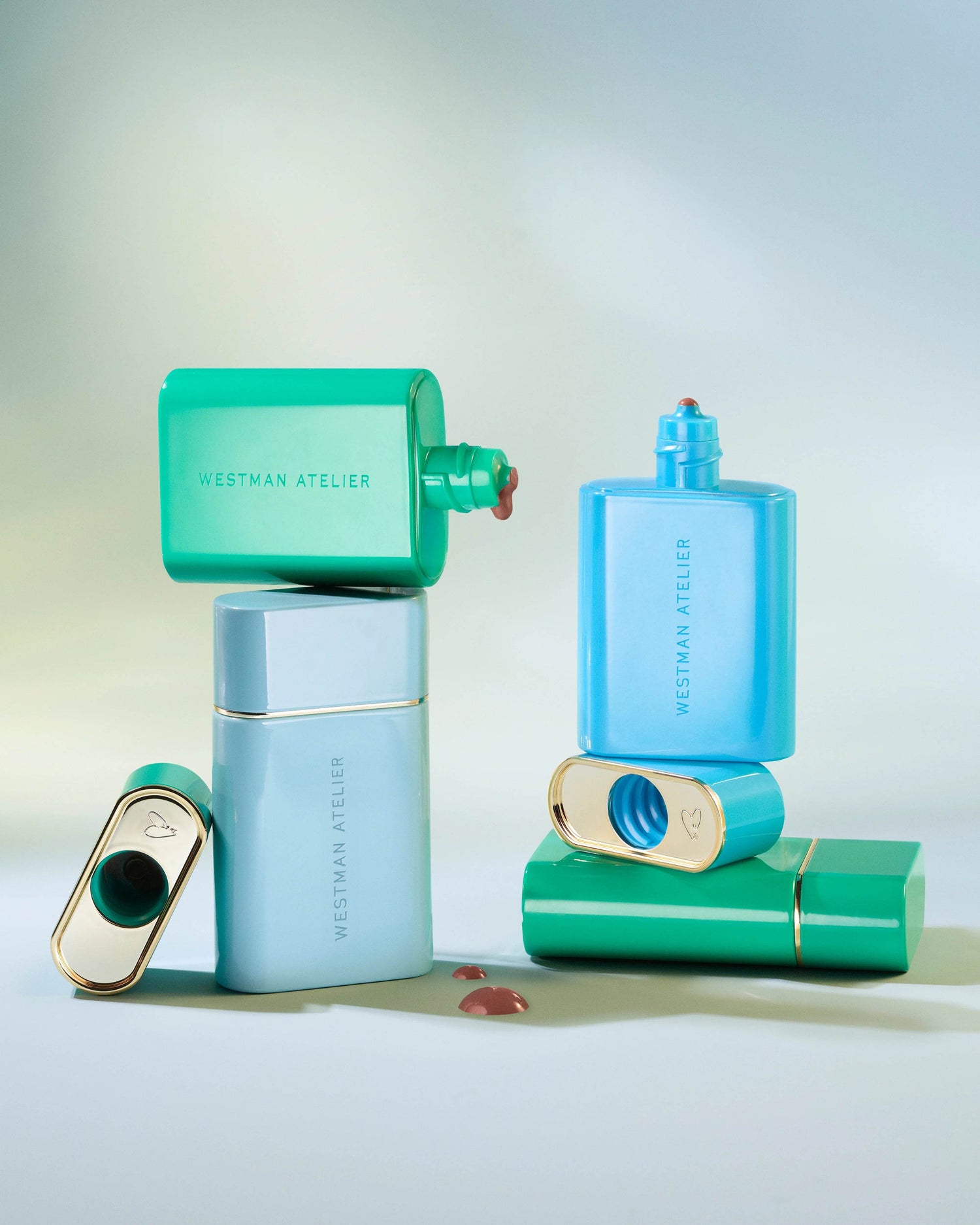 New In collection of Westman Atelier makeup products in blue and green sleek packaging with foundation swatches