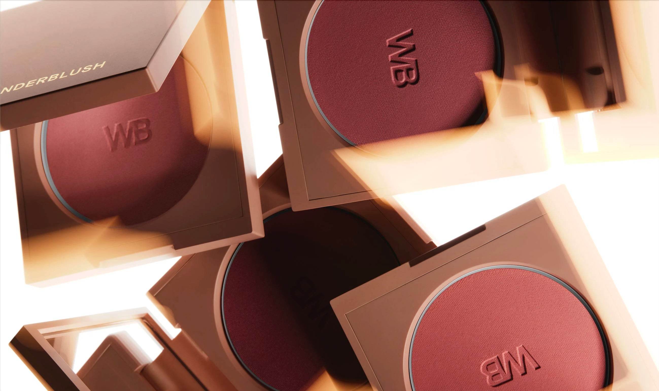 Close-up of rich rosy powder blushes in multiple compact cases from the Cheeks collection