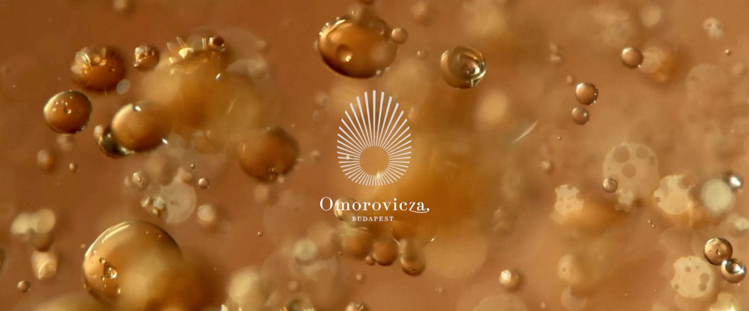 Omorovicza collection image with mineral-rich thermal water bubbles and branded logo on a golden background