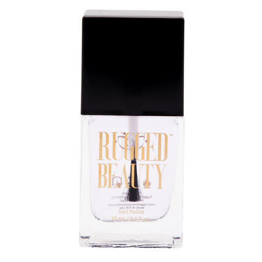 A bottle of Rugged Beauty clear nail polish with a black cap and gold lettering on the front, set against a plain white background.