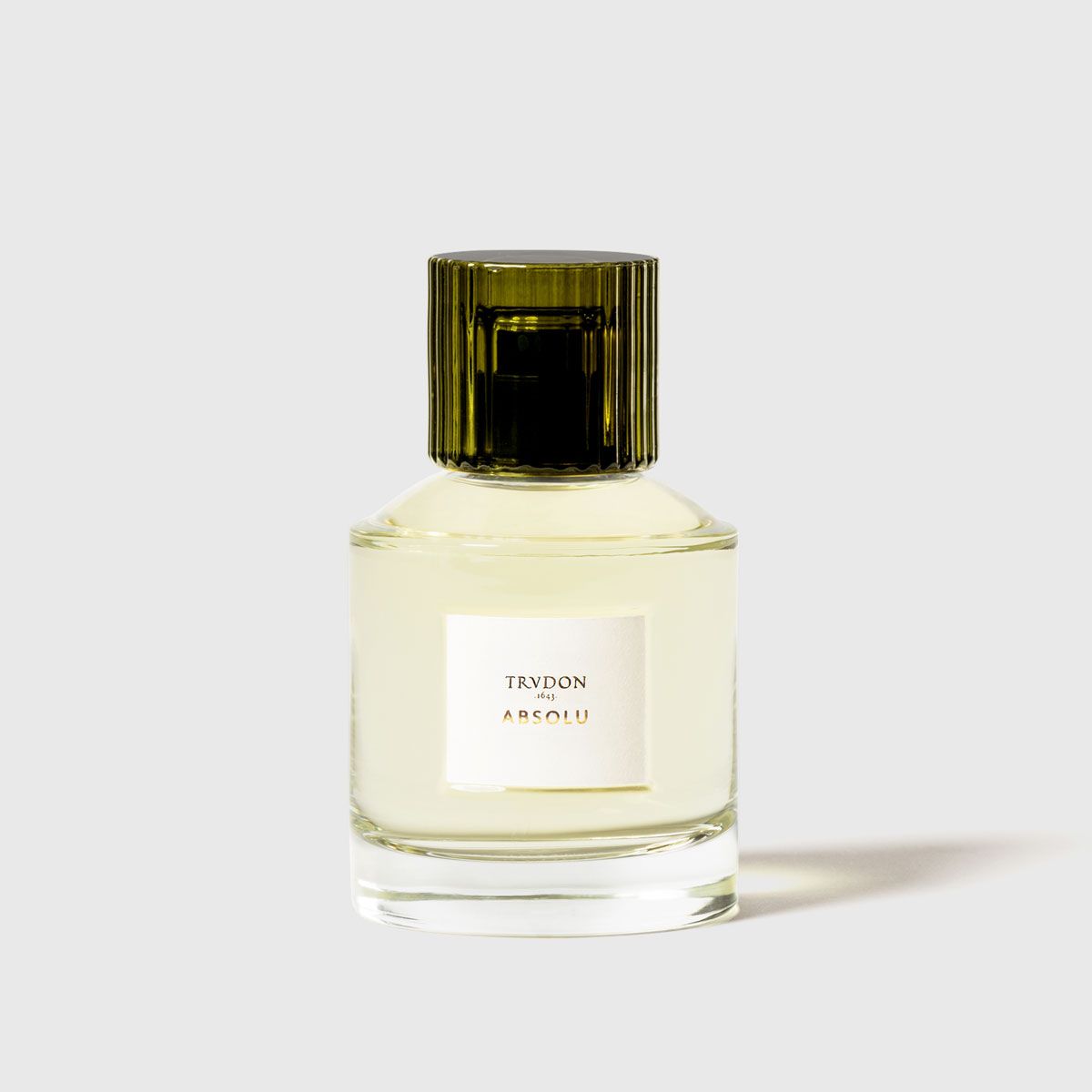 Trudon Absolu Eaux de Parfum in a sleek glass bottle with a green cap for a luxurious fragrance experience