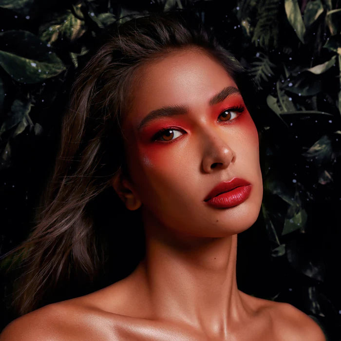 Model showcasing vibrant makeup with Rituel de Fille Jelly Blush and Lip Color for a bold look