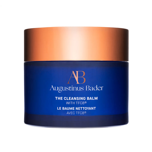 Augustinus Bader The Cleansing Balm in a blue jar with a gold lid for nourishing skin care