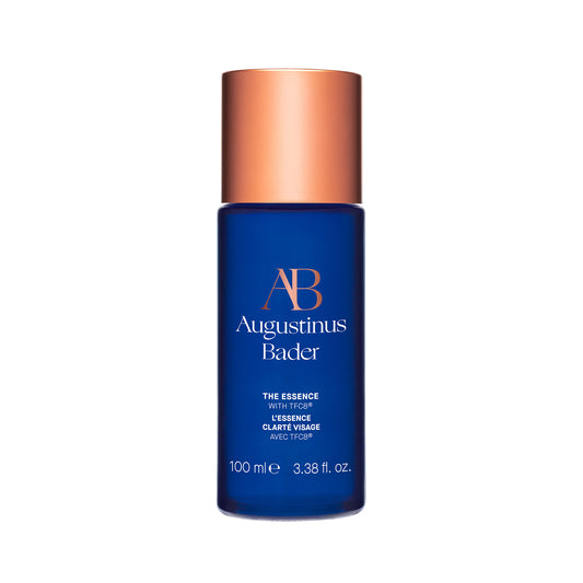 Augustinus Bader The Essence 100ml skincare product in a blue bottle with a copper cap for rejuvenating skin