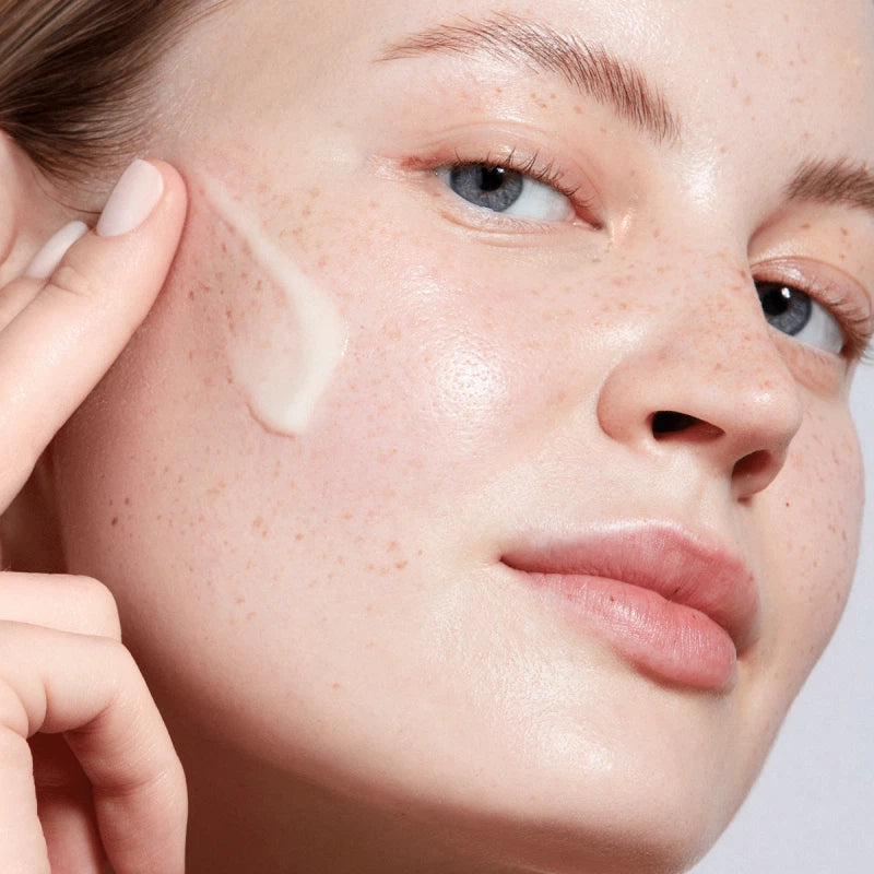 Model applying The Serum by Augustinus Bader for radiant and hydrated skin
