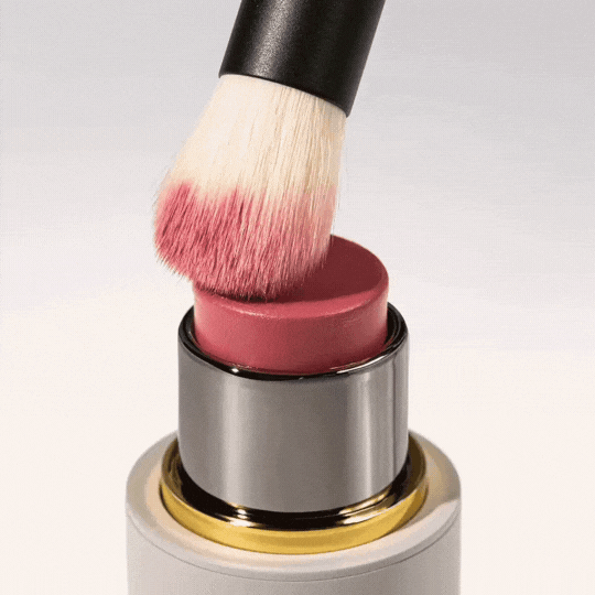 Westman Atelier Baby Blender Brush applying cream blush directly from the tube for a flawless finish