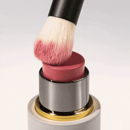 Westman Atelier Baby Blender Brush applying cream blush directly from the tube for a flawless finish