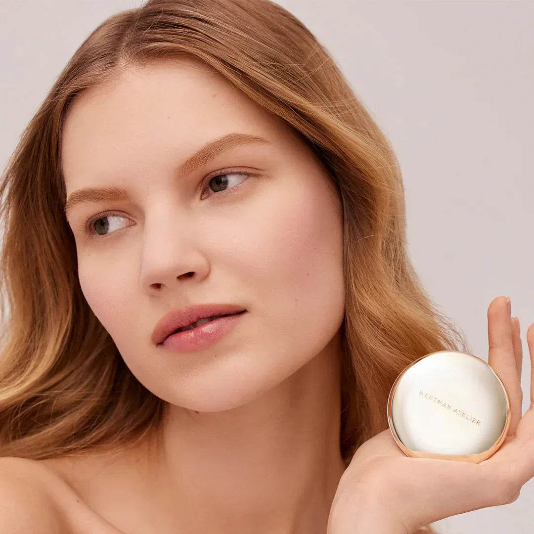 Westman Atelier Pressed Powder with a Natural Finish, modeled by a woman with soft features