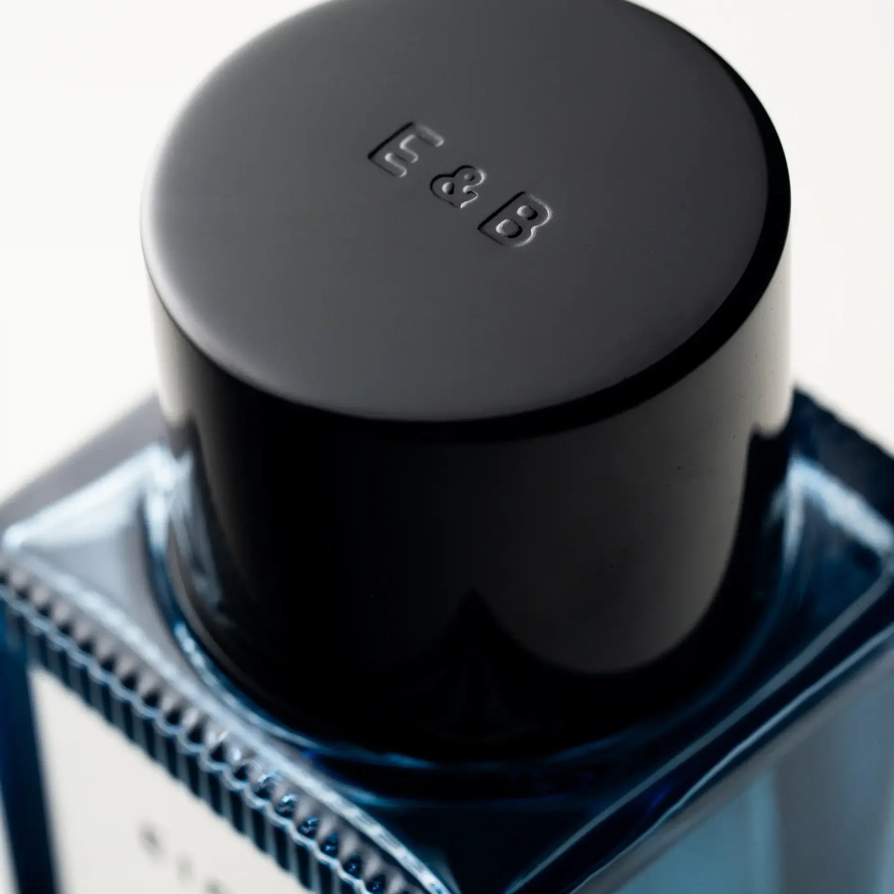 Close-up of a black bottle cap with 'E88' branding on a white background