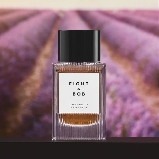 Perfume bottle with 'Eight & Bob' label against a lavender field background