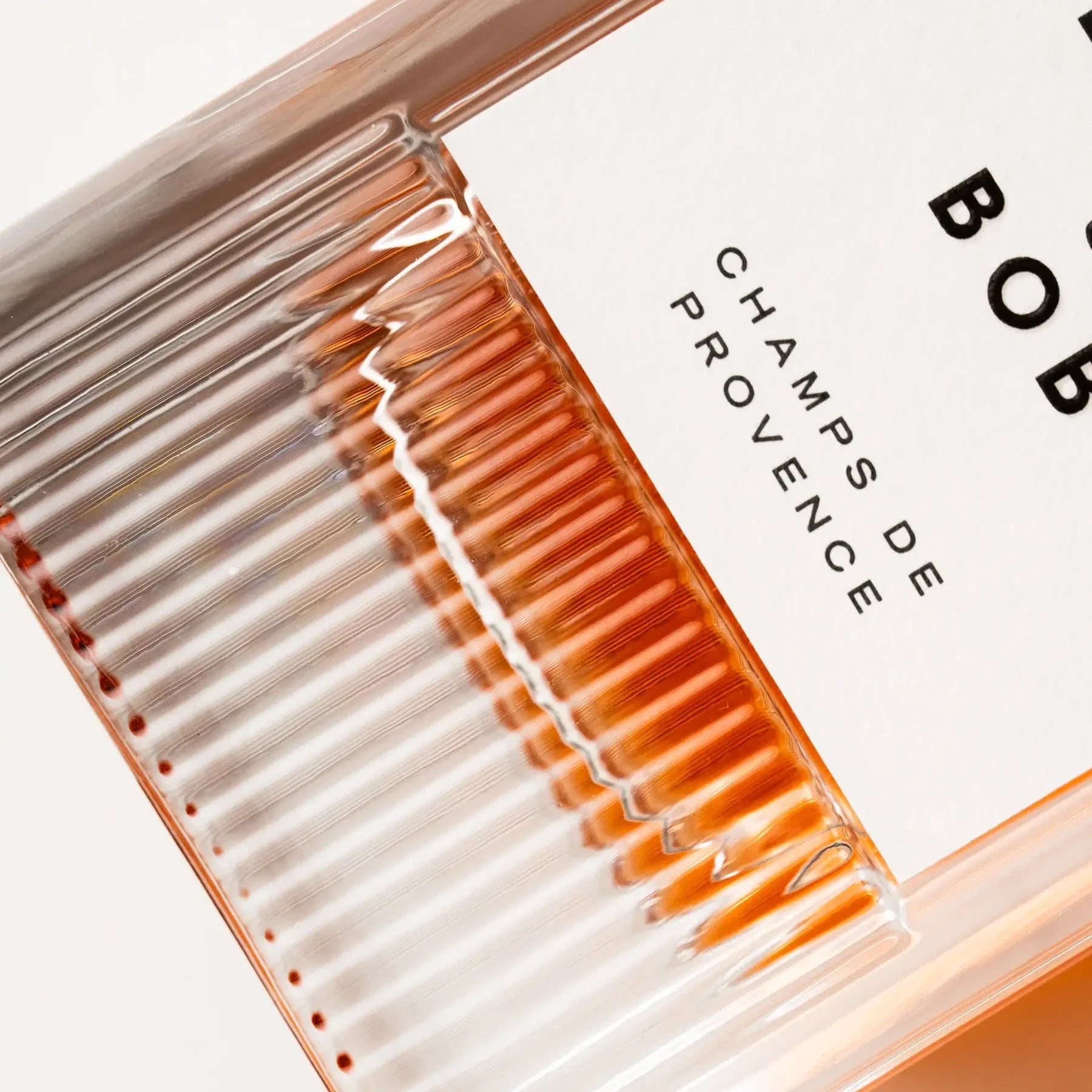 Close-up of a cosmetic product with 'EIGHT & BOB' branding and 'Champs de Provence' text.