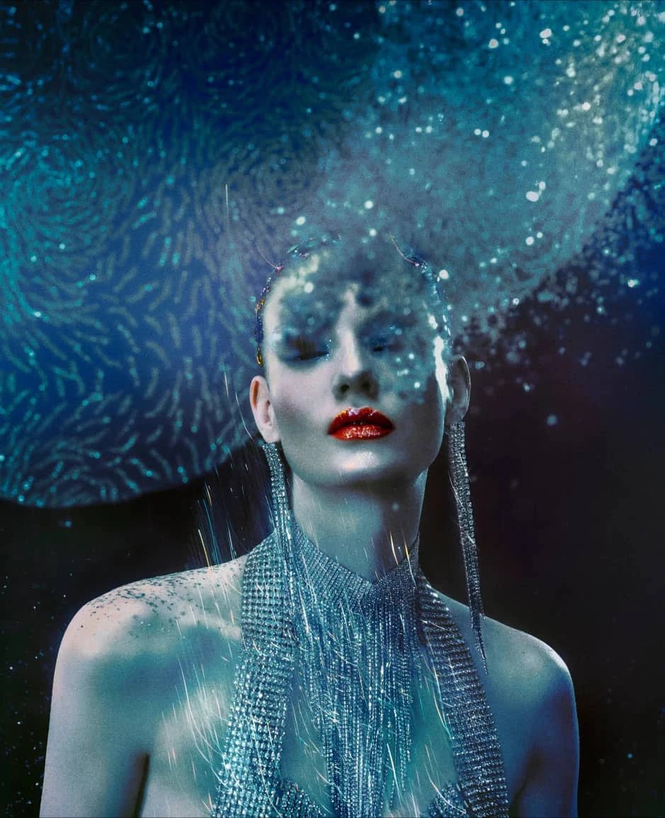 Cirque Du Soleil performer showcasing a unique gourmand fragrance with artistic blue and sparkly background