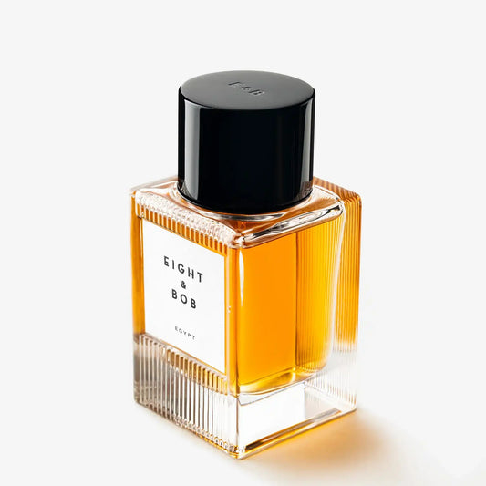 Perfume bottle with black cap and 'Eight & Bob' label on a white background