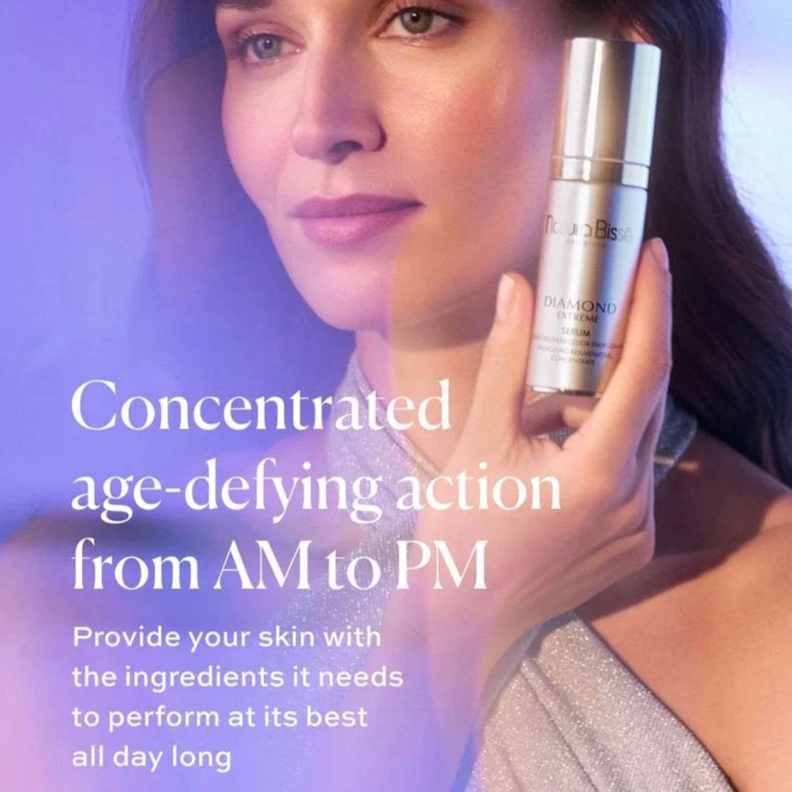 Natura Bisse Energizing Rejuvenating Luxury Serum held by a woman promoting age-defying skincare