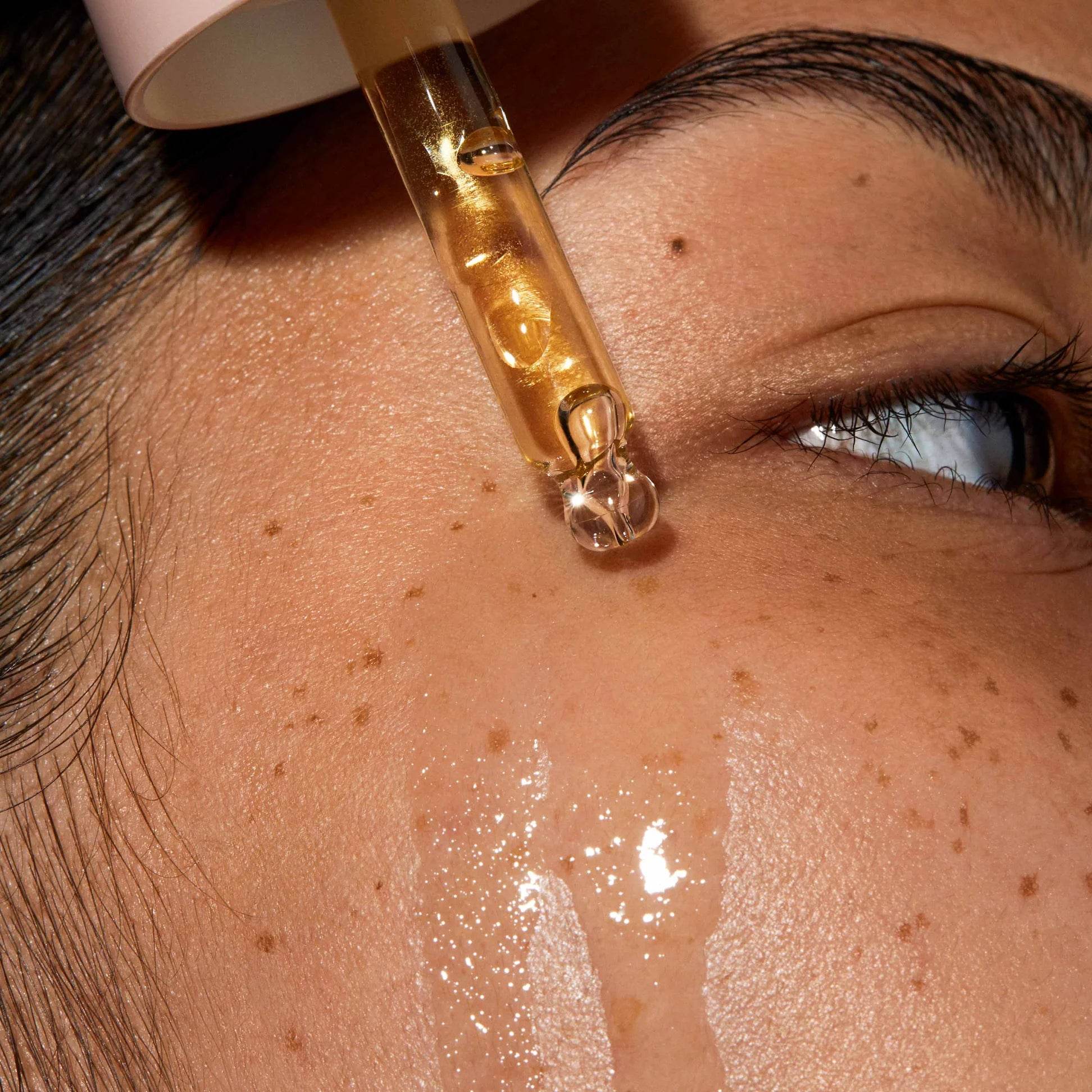 Omorovicza Facial Oil dropper releasing nourishing oil onto skin for a glowing complexion