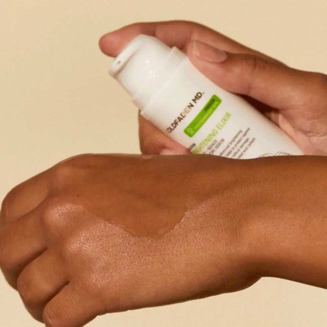 Goldfaden MD Brightening Elixir Hydrating Brightening Serum being applied on hand for glowing skin