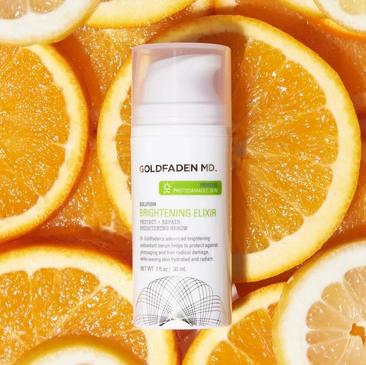 Goldfaden MD Brightening Elixir Hydrating Brightening Serum in white bottle with orange slices background