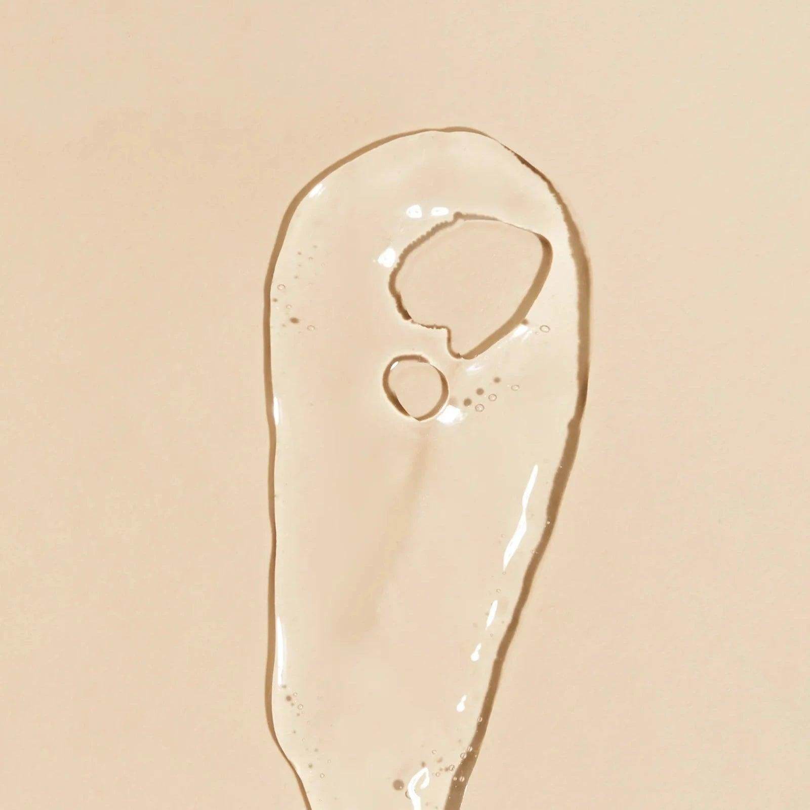 Clear gel texture of Goldfaden MD Fresh A Peel | Multi Acid Resurfacing Peel on beige surface
