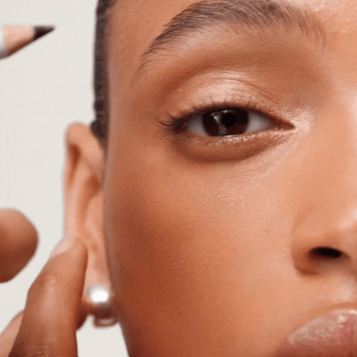 Close-up of a model applying Westman Atelier Kohl Eye Pencil for defined eye makeup