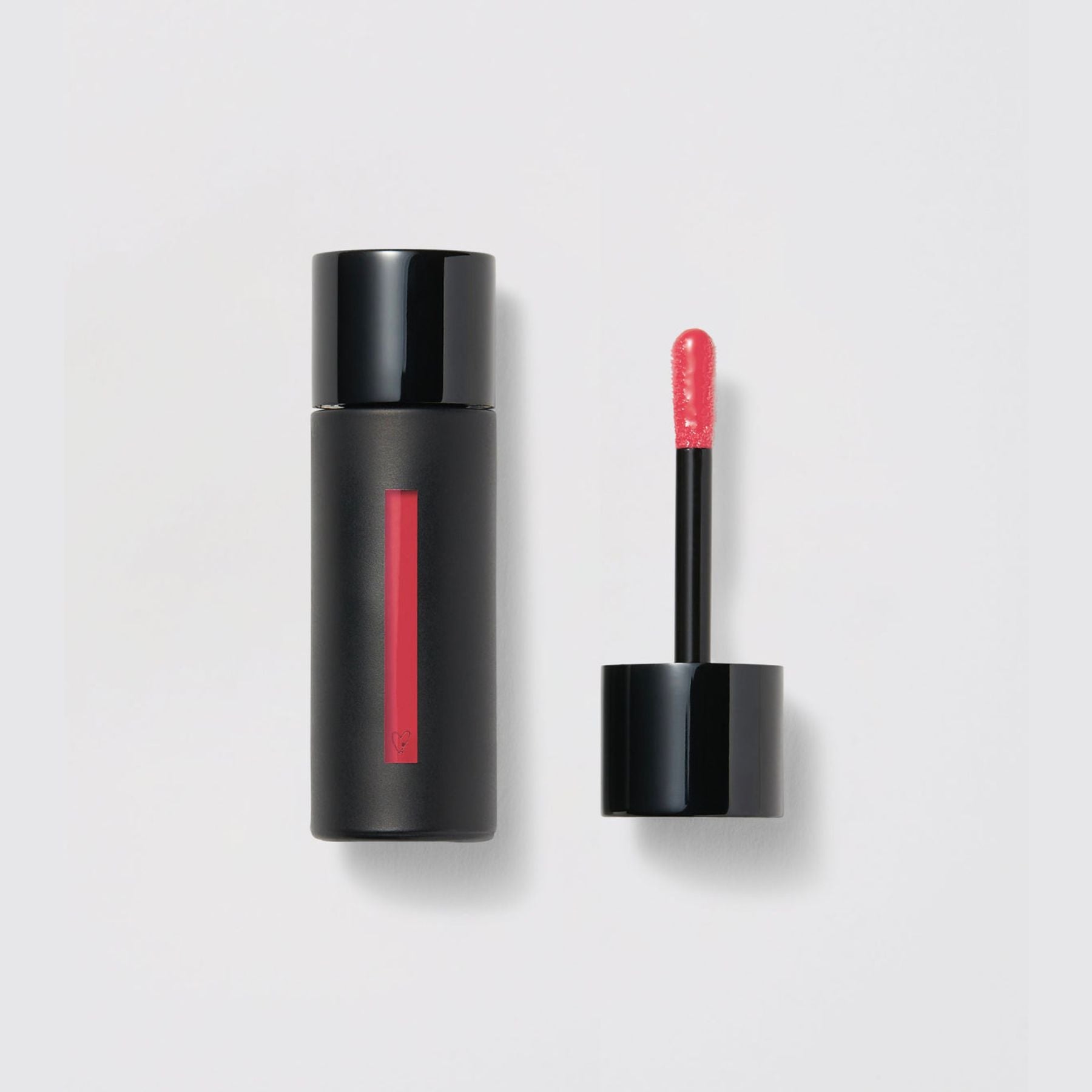 Westman Atelier Liquid Tinted Lip Balm in a sleek black tube with applicator for vibrant lips