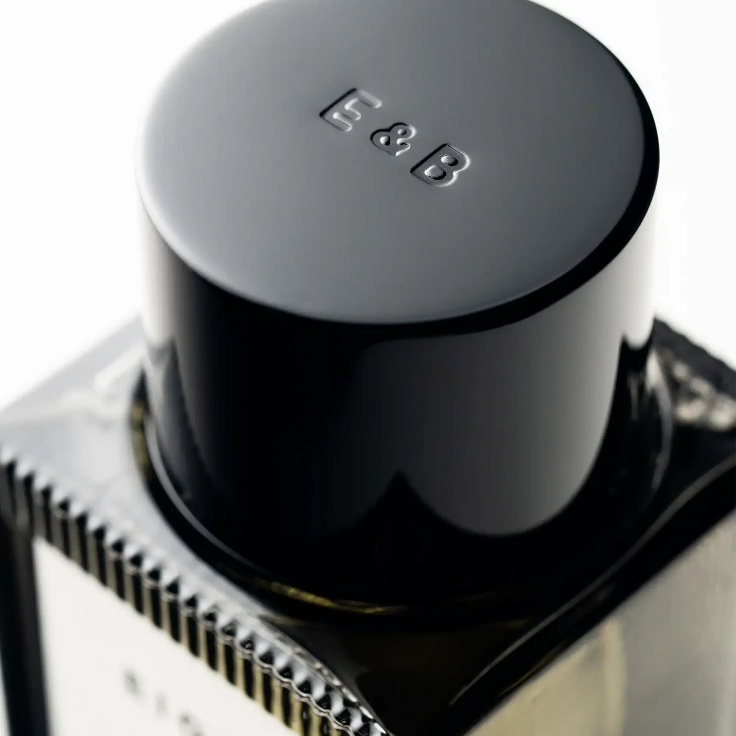 Close-up of a black cylindrical object with 'E&B' branding on a white background