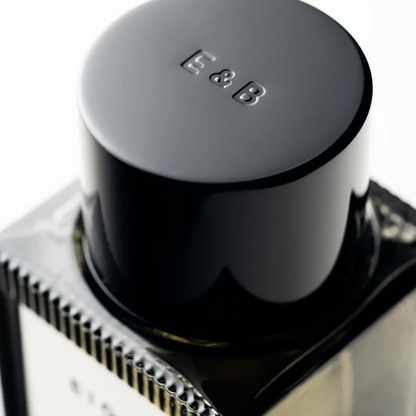 Close-up of a black cylindrical object with 'E&B' branding on a white background