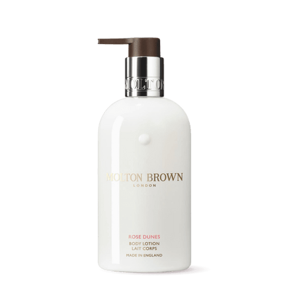 Molton Brown Rose Dunes Body Lotion in a sleek white bottle with a pump for hydration
